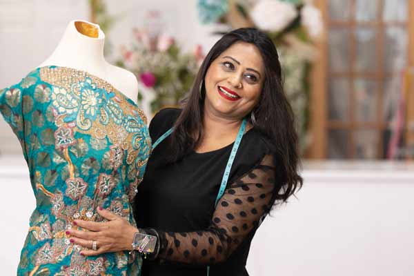 Sonu creating custom couture on dress form