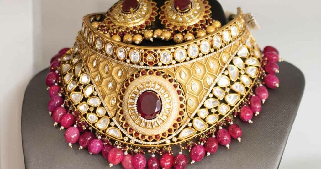 Close-up of a beautiful gold and red ethnic necklace with matching earrings.