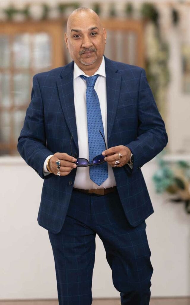 Man wearing high quality blue suit and blue tie.