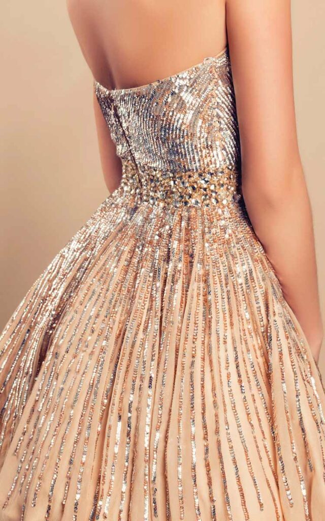 Close-up of the back of a woman wearing a sparkly party dress with sequins.